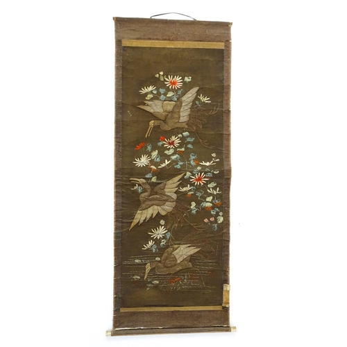 1253 - An Oriental embroidered scroll decorated with birds, flowers and foliage. Together with a Chinese sc... 