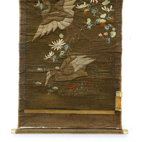 1253 - An Oriental embroidered scroll decorated with birds, flowers and foliage. Together with a Chinese sc... 