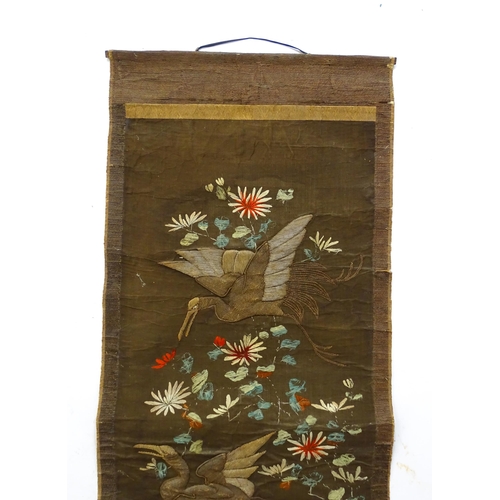 1253 - An Oriental embroidered scroll decorated with birds, flowers and foliage. Together with a Chinese sc... 