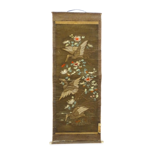 1253 - An Oriental embroidered scroll decorated with birds, flowers and foliage. Together with a Chinese sc... 