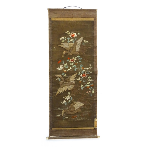 1253 - An Oriental embroidered scroll decorated with birds, flowers and foliage. Together with a Chinese sc... 