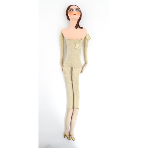 1277 - Toy: A 20thC French cloth boudoir doll body, with straw filled body and bisque hands and lower legs.... 