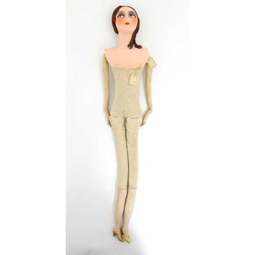 1277 - Toy: A 20thC French cloth boudoir doll body, with straw filled body and bisque hands and lower legs.... 