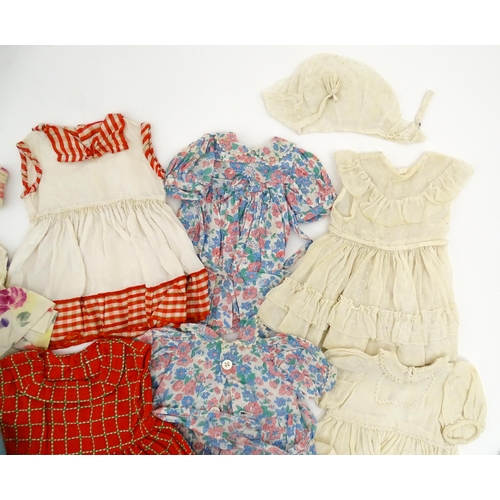 1287 - A large quantity of dolls clothing to include knitted cardigans, dresses, summer dresses, bonnets, e... 