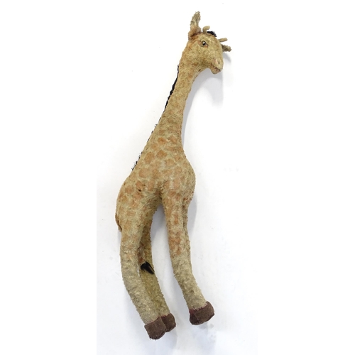 1291 - Toy: A large 20thC straw filled giraffe with glass eyes. Approx. 36 1/2