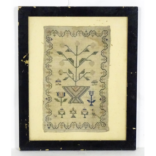 1251 - A 19thC needlework embroidery depicting a fruit tree, flowers and a bird, with a foliate border. App... 