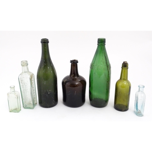 234 - Seven assorted glass bottles to include a late 17th / early 18thC dark olive mallet bottle, Stephen ... 