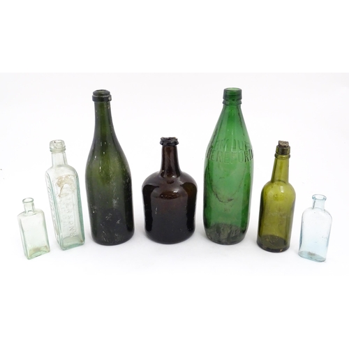 234 - Seven assorted glass bottles to include a late 17th / early 18thC dark olive mallet bottle, Stephen ... 