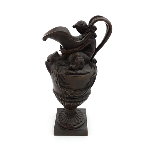 1228 - A 19thC cast bronze ewer cast in the Classical style modelled with Neptune supporting the spout and ... 