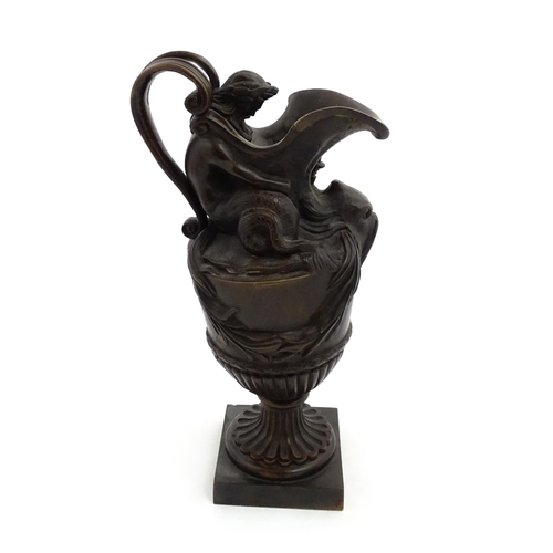 1228 - A 19thC cast bronze ewer cast in the Classical style modelled with Neptune supporting the spout and ... 