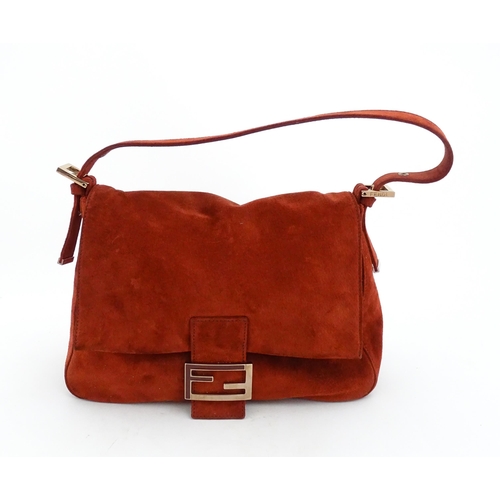 1263 - Vintage fashion / clothing: A Fendi Mamma Baguette handbag in red suede, numbered 2579-8BR001.019. A... 