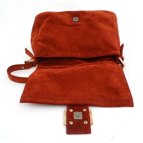 1263 - Vintage fashion / clothing: A Fendi Mamma Baguette handbag in red suede, numbered 2579-8BR001.019. A... 