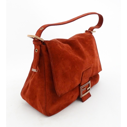 1263 - Vintage fashion / clothing: A Fendi Mamma Baguette handbag in red suede, numbered 2579-8BR001.019. A... 