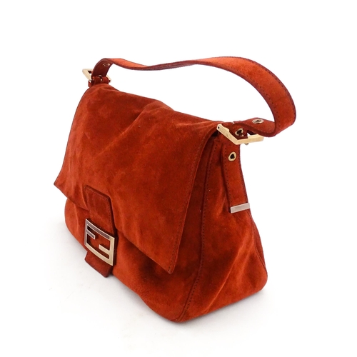 1263 - Vintage fashion / clothing: A Fendi Mamma Baguette handbag in red suede, numbered 2579-8BR001.019. A... 