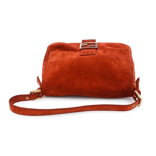 1263 - Vintage fashion / clothing: A Fendi Mamma Baguette handbag in red suede, numbered 2579-8BR001.019. A... 