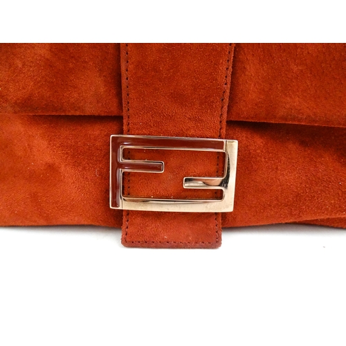 1263 - Vintage fashion / clothing: A Fendi Mamma Baguette handbag in red suede, numbered 2579-8BR001.019. A... 