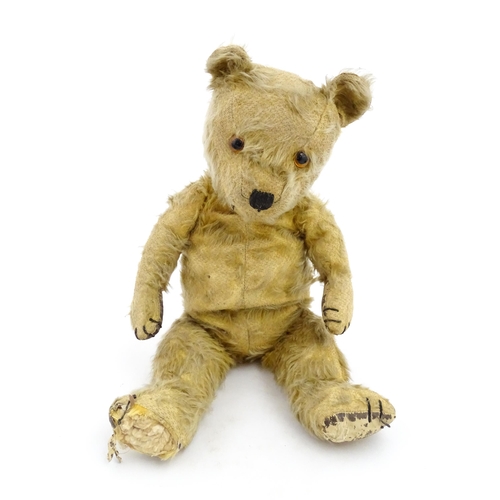 1270 - Toy: A 20thC teddy bear with stitches nose and claws, and articulated limbs. Approx. 16 1/4