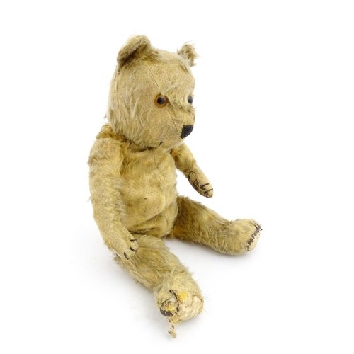 1270 - Toy: A 20thC teddy bear with stitches nose and claws, and articulated limbs. Approx. 16 1/4