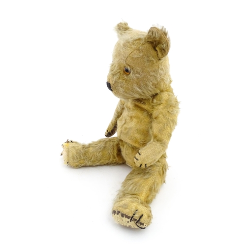 1270 - Toy: A 20thC teddy bear with stitches nose and claws, and articulated limbs. Approx. 16 1/4