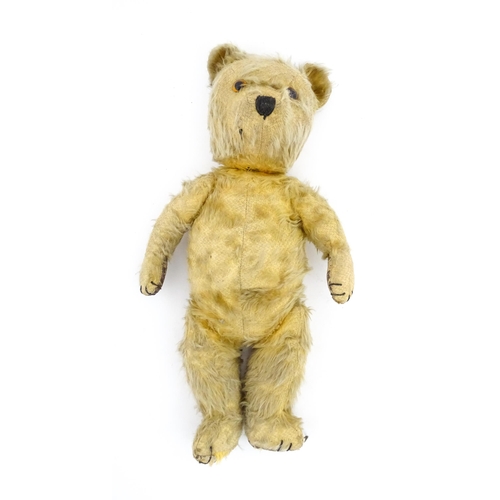 1270 - Toy: A 20thC teddy bear with stitches nose and claws, and articulated limbs. Approx. 16 1/4