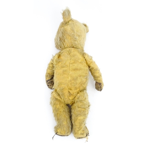 1270 - Toy: A 20thC teddy bear with stitches nose and claws, and articulated limbs. Approx. 16 1/4