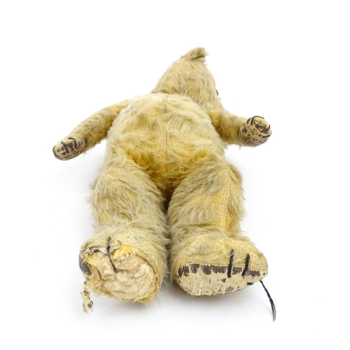 1270 - Toy: A 20thC teddy bear with stitches nose and claws, and articulated limbs. Approx. 16 1/4