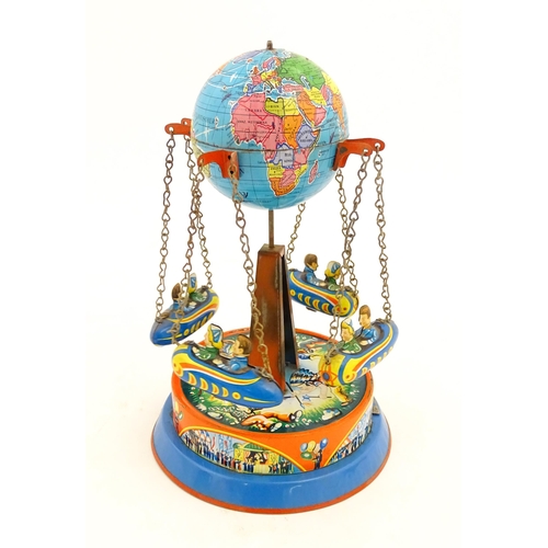 1271 - Toy: A vintage tin plate toy modelled as a fairground ride / carousel with world globe to top suppor... 