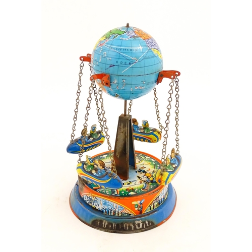 1271 - Toy: A vintage tin plate toy modelled as a fairground ride / carousel with world globe to top suppor... 