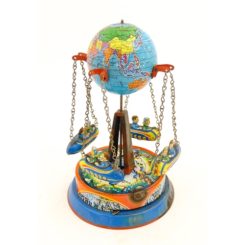 1271 - Toy: A vintage tin plate toy modelled as a fairground ride / carousel with world globe to top suppor... 