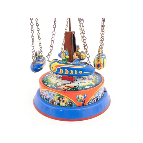 1271 - Toy: A vintage tin plate toy modelled as a fairground ride / carousel with world globe to top suppor... 