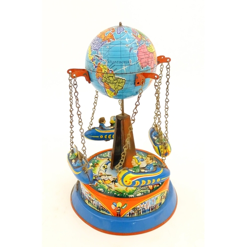 1271 - Toy: A vintage tin plate toy modelled as a fairground ride / carousel with world globe to top suppor... 