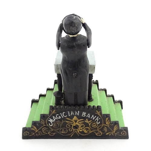 1273 - Toy: A 20thC cast metal novelty money box / piggy bank titled Magician Bank, modelled as a magician ... 