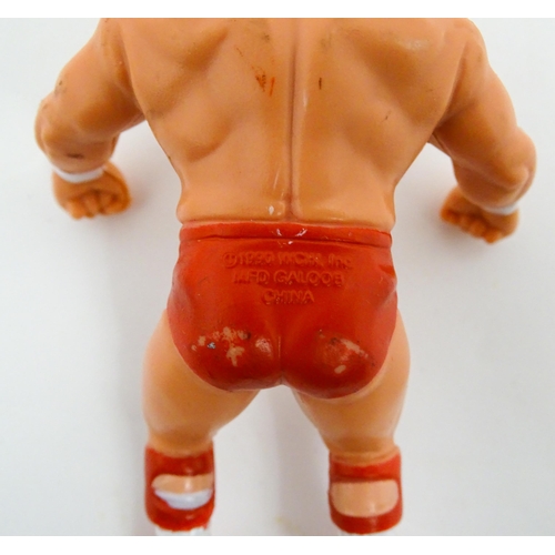 1276 - Toys: A 20thC WWF Wrestlemania wrestling ring, with Titan Sport American wrestler action figures to ... 