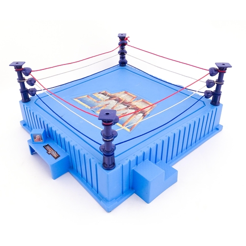 1276 - Toys: A 20thC WWF Wrestlemania wrestling ring, with Titan Sport American wrestler action figures to ... 