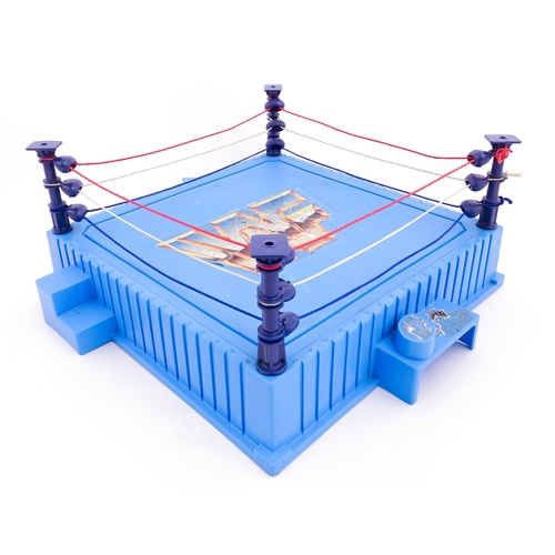 1276 - Toys: A 20thC WWF Wrestlemania wrestling ring, with Titan Sport American wrestler action figures to ... 