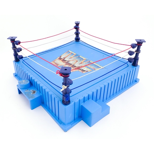 1276 - Toys: A 20thC WWF Wrestlemania wrestling ring, with Titan Sport American wrestler action figures to ... 