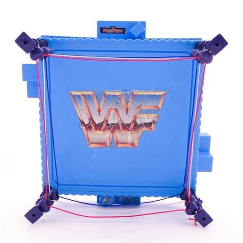 1276 - Toys: A 20thC WWF Wrestlemania wrestling ring, with Titan Sport American wrestler action figures to ... 