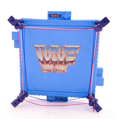 1276 - Toys: A 20thC WWF Wrestlemania wrestling ring, with Titan Sport American wrestler action figures to ... 