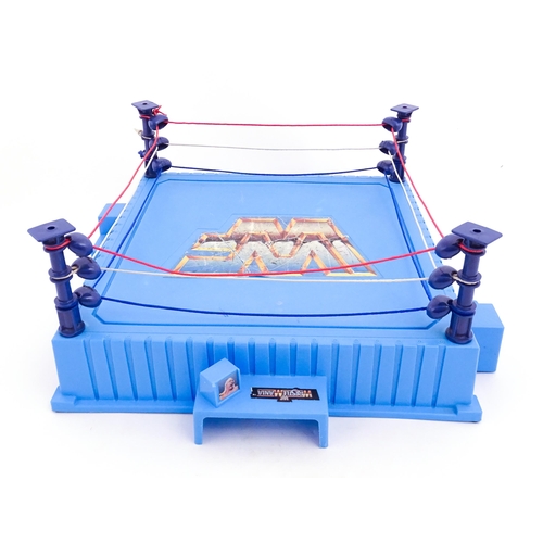 1276 - Toys: A 20thC WWF Wrestlemania wrestling ring, with Titan Sport American wrestler action figures to ... 