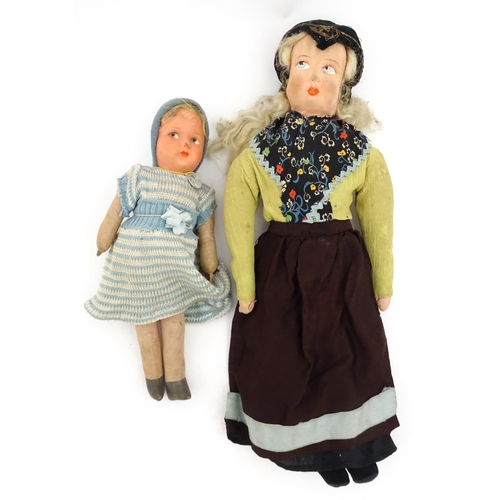 1278 - Toys: A Continental 20thC cloth doll with painted features. Together with a straw filled doll with c... 