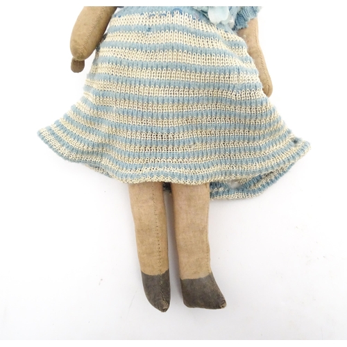 1278 - Toys: A Continental 20thC cloth doll with painted features. Together with a straw filled doll with c... 