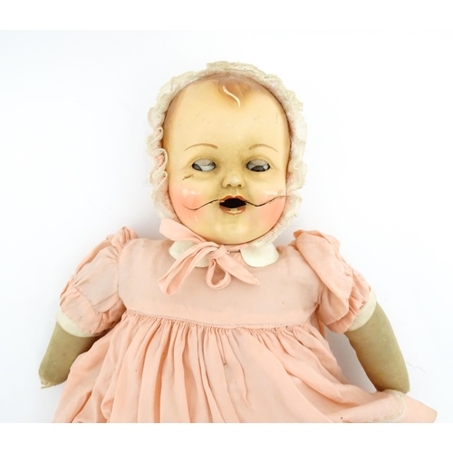 1280 - Toys: A 20thC Raynal doll with rhodoid head and cloth body. Together with a 20thC composite doll. La... 