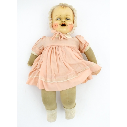 1280 - Toys: A 20thC Raynal doll with rhodoid head and cloth body. Together with a 20thC composite doll. La... 