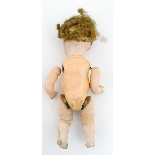 1281 - Toys: A small German doll with a bisque head and composite body. Together with a quantity of doll pa... 