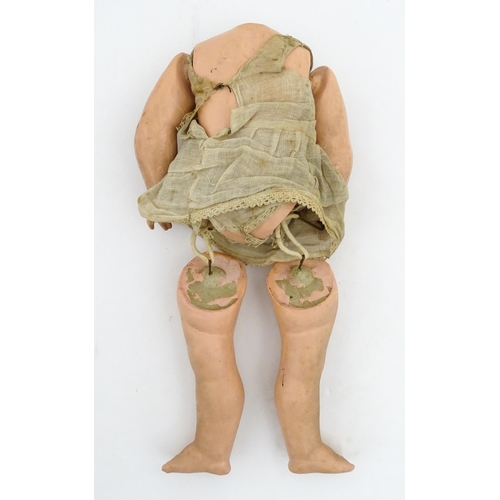 1281 - Toys: A small German doll with a bisque head and composite body. Together with a quantity of doll pa... 