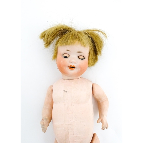 1281 - Toys: A small German doll with a bisque head and composite body. Together with a quantity of doll pa... 