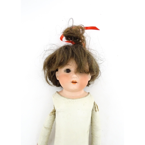 1282 - Toy: A 20thC Heubach Koppelsdorf German doll with bisque head and articulated leather body. Approx. ... 