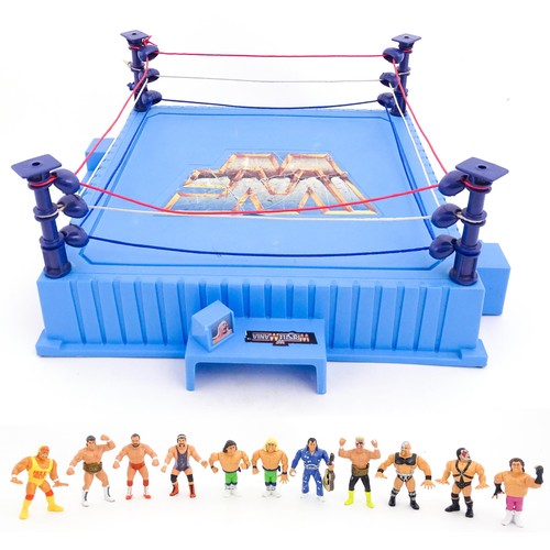 1276 - Toys: A 20thC WWF Wrestlemania wrestling ring, with Titan Sport American wrestler action figures to ... 