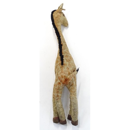 1291 - Toy: A large 20thC straw filled giraffe with glass eyes. Approx. 36 1/2