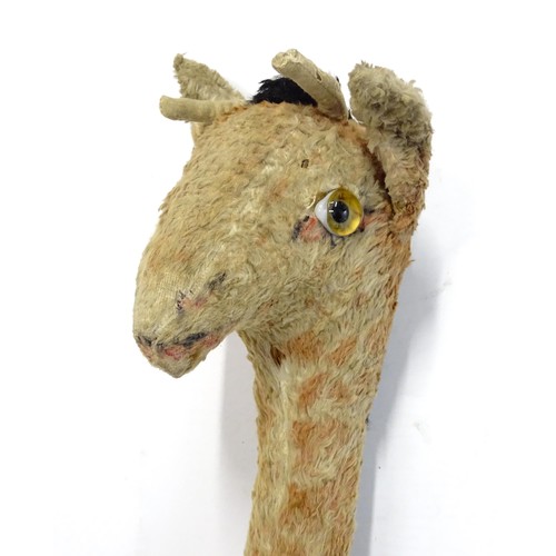 1291 - Toy: A large 20thC straw filled giraffe with glass eyes. Approx. 36 1/2